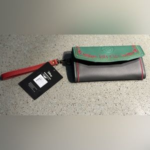 Brand new Danielle Nicole wristlet wallet. Measures 7.5”x4”